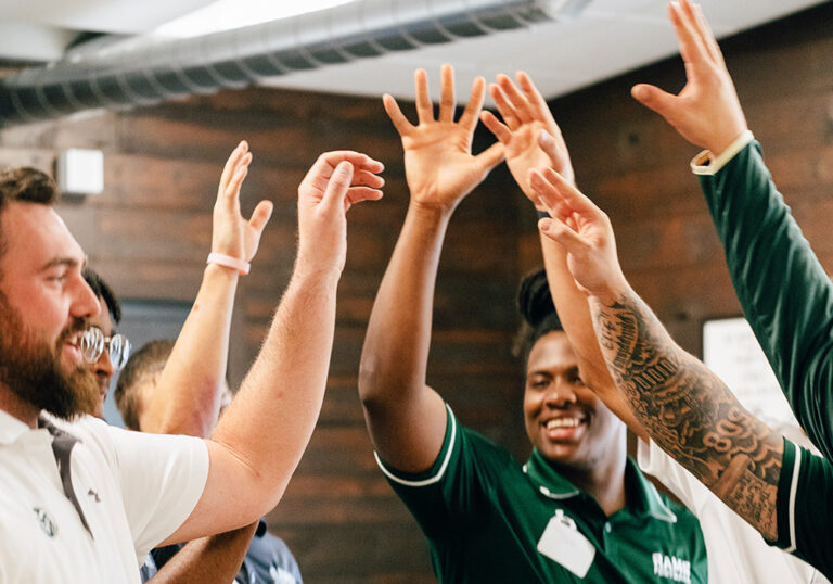 People celebrating with raised hands